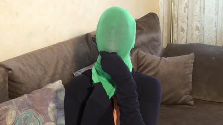 Multilayer Pantyhose Mask - Lara is completely encased in black tights. Then she pulls as many pantyhose over her head as she can. But that is not easy. Even when she pulls the tights off her head she has some problems. How many layers does she manage.....