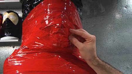 3 Layers Part 3 - Our slut is all secured and bound in plastic wrap and bondage tape, her breasts are covered in pegs, so now we have some fun with her breathing as we cover her mouth hole with a piece of bondage tape and watch her squirm.