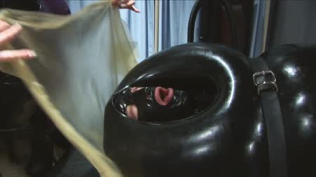 Sweating In Rubber - Warden r69 enjoys making people sweat and this poor prisoner is under layers of latex and heavy rubber, before she puts him in the inflatable bondage sack and belts him in tight. With only his head showing she covers his face with a thin transparent latex sheet. It soon becomes clear to him she isnt playing as he struggles to remove the latex from his face, but the warden keeps is sealed down tight!!!