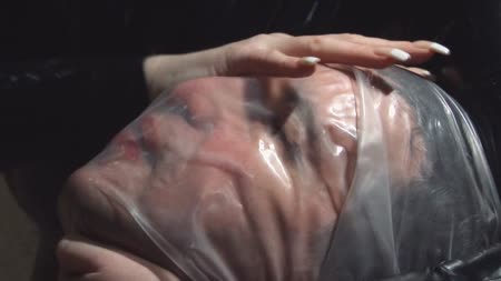 No Air - The warden shoves her prisoner inside the plastic ***** sack and zips it shut, now he can rely on his own air supply rather than polute hers. She isnt happy though with how long its taking for him to use that air up so she grips the plastic sack tight around his neck and is soon much happeir with the results!