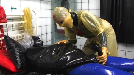 Bizarre Rubber Milking  Complete Movie - Cocooned in the rubber straight jacket, the kinky rubber nurse rubs his cock through the rubber and feels it groan. She must punish this patient so she takes a plastic bag and slips it over his head and seals is shut, now she has total control over his every breath. All the time she teases his rubber covered cock.  Now the nurse zips up his latex hood totally covering his face, leaving him only two small holes to breathe through. To make maters worse she covers this with a plastic bag as she then decides to fuck her rubber patient and use his cock for her pleasure