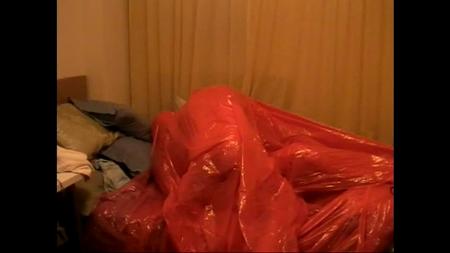 Red Wrap And Red Tree Bag - This time the instructor and acolyte "e" don head to toe red plastic wrap bodysuits, and they both enter a red plastic christmas tree removal bag. Enlightenment follows.
